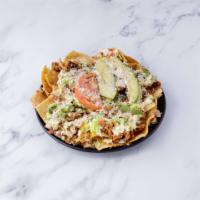 Nachos · Corn tortilla chips topped with refried beans, cheese, sour cream, lettuce, tomato, cilantro...