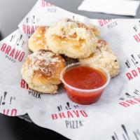 5 Garlic Knots  · A classic snack, our garlic knots are strips of pizza dough tied in a knot, baked, and then ...