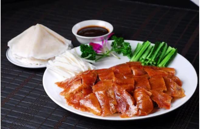 Peking Duck  （Whole） · Include ：Whole cut Peking duck；10pcs Lotus leaf pancake；Cucumber；Shallot；Sauce
