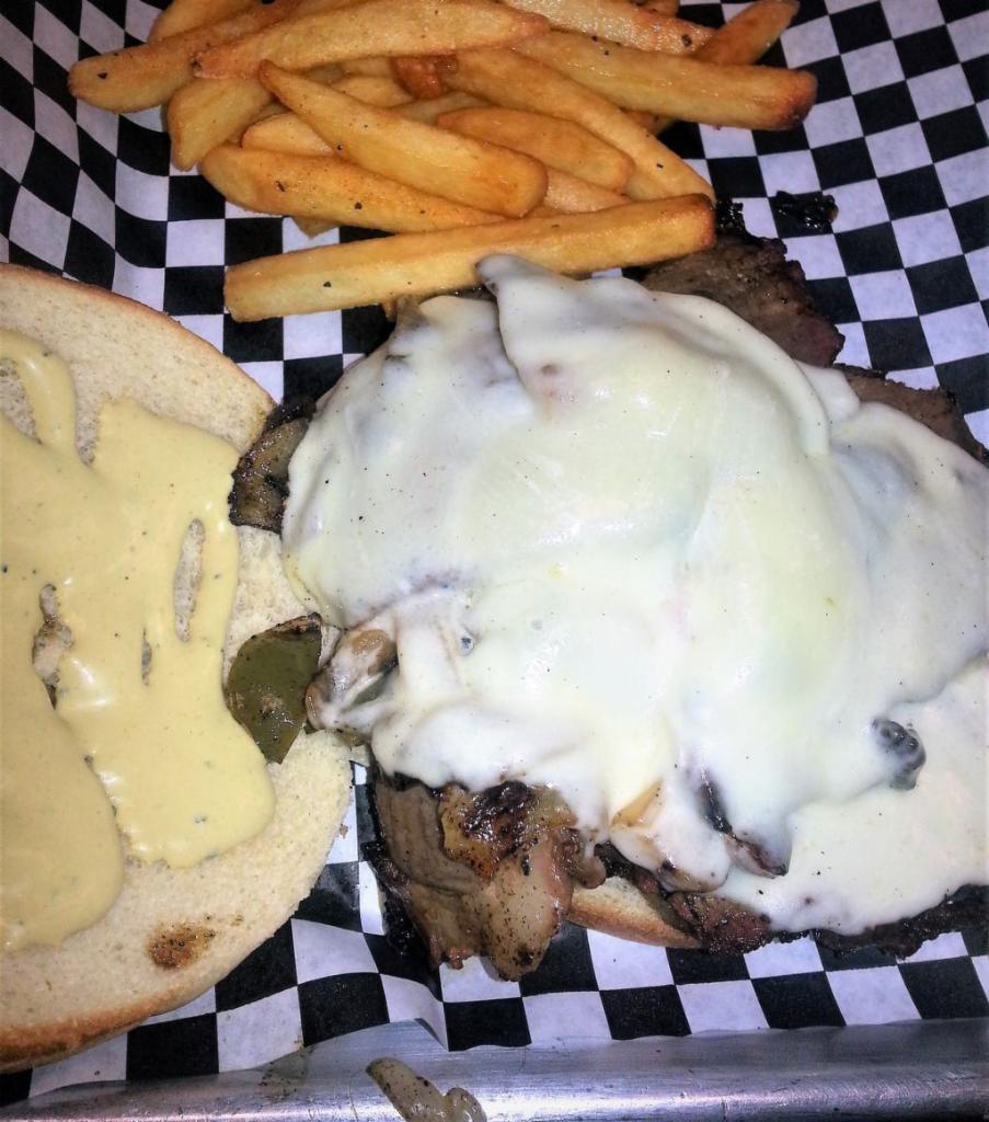 Smokehouse Steak Sandwich · Slow smoked prime rib, thinly sliced then grilled on a bed of onions and bell pepper, then smothered with two slices of Provolone cheese and served up with our special sauce on a deluxe bun. Jumbo.