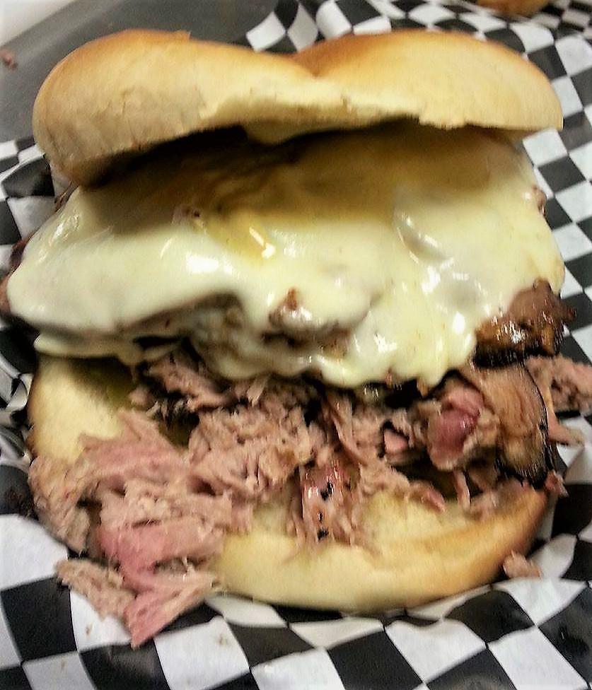 Ty's Cuban Sandwich · 4 oz. pulled pork and four oz. smoked ham with Provolone cheese pickles and our own special sauce on a jumbo bun.