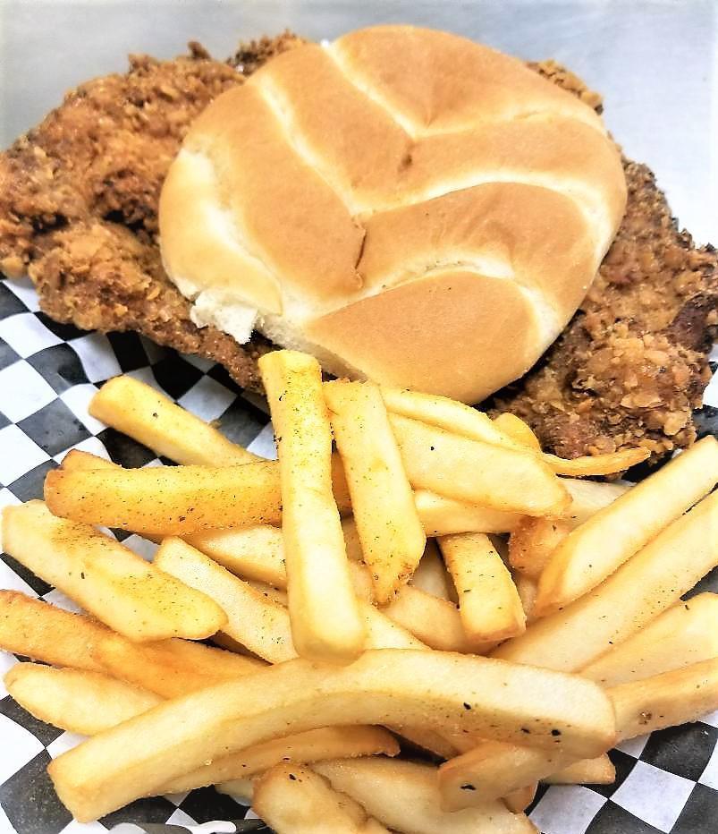Iowa Tenderloin Sandwich · A thick slice of pork loin pounded out flat and seasoned then breaded and deep fried and served on a bun with pickles.