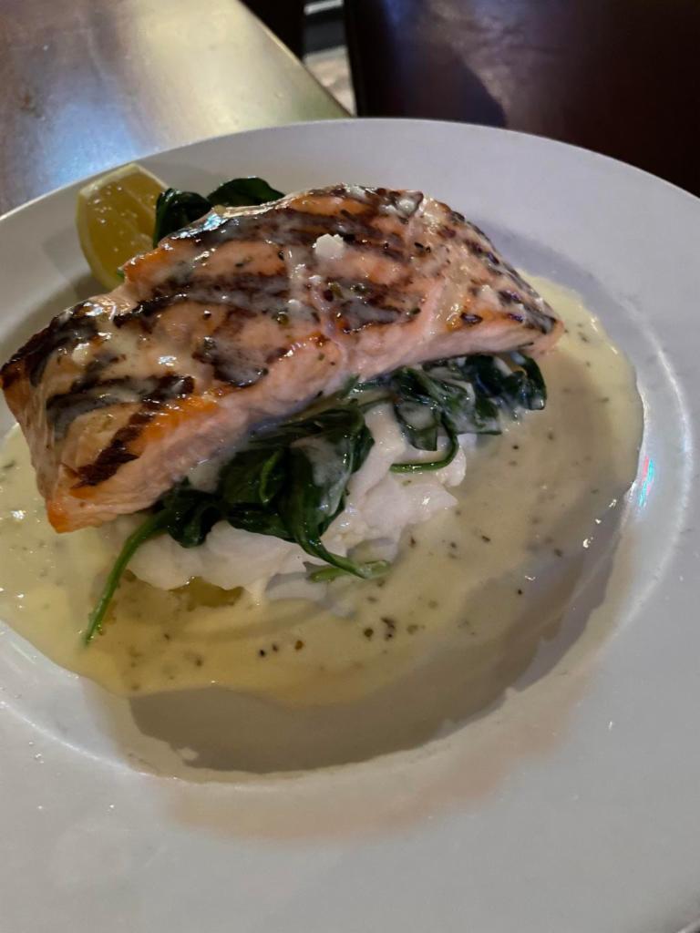 Grilled Salmon in a Lemon Butter Sauce  · Filet of Salmon Grilled Topped with a Lemon Butter Sauce & Served on a Bed of Spinach & Mashed Potatoes