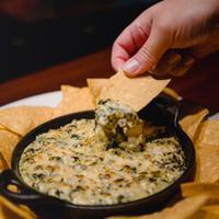 Spinach & Artichoke Dip  · Creamy spinach and artichoke dip topped with Parmesan cheese and served with crisp tortilla ...