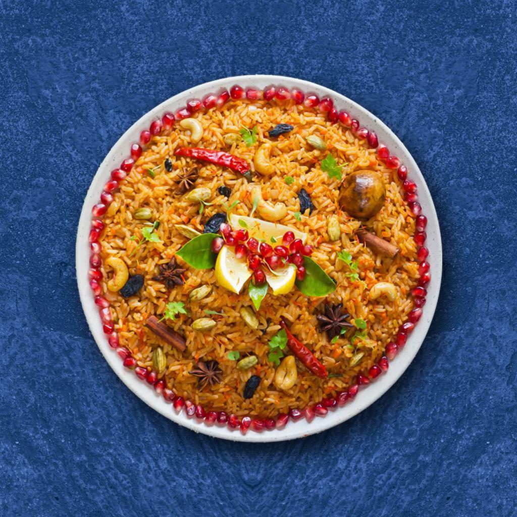 Veggie Bayside Biryani · Aromatic rice flavored with garden fresh vegetables, fragrant with saffron, garnished with raisins and cashews
