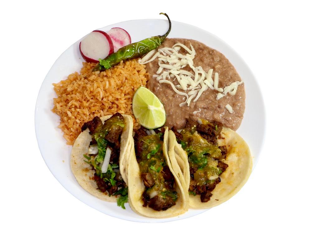 #3 - 3 Tacos Plate · The famous street tacos! Corn tortillas with your choice of filling, including onions, and fresh cilantro. Served with homemade rice and beans, a serrano pepper, radishes, and lime on the side. Your choice of a canned soda to complete the meal.