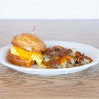 Croissant Breakfast Sandwich · Choice of ham, bacon or sausage with scrambled eggs and cheese. Served with hash browns.