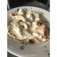 Crab Ravioli · Roasted red pepper ravioli stuffed with crabmeat served with shrimp in a creamy vino sauce