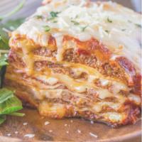 Lasagna alla Bolognese · A Baked Italian Dish Consisting Of Wide Strips Of Pasta Cooked And Layered With Meat.Ricotta...