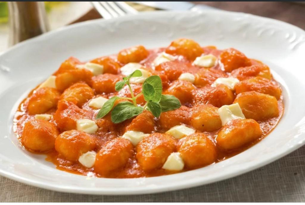 Gnocchi alla Sorrentina · Homemade Potato Dumpling in fresh tomato sauce topped with Mozzarella cheese