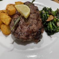 New York Strip Steak  · Grilled New York steak, served with roasted potatoes and sauteed broccoli rabe. 
