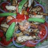 Mediterranean Salad · Fresh arugula, red onions, tomatoes, avocado and roasted peppers with grilled chicken and gr...