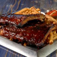 Slow-Smoked Espresso Baby Back Ribs · Full rack of smoked ribs with our house espresso BBQ sauce, hand cut fries and creamy colesl...