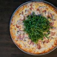 Shrimp Alfredo Pizza · Pancetta, shrimp, red onions, Alfredo sauce, mozzarella, and fresh arugula.