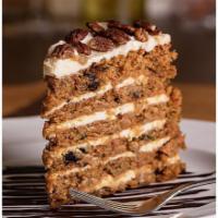 Carrot Cake · Studded with raisins, walnuts and pineapple, finished with a smooth cream cheese icing.