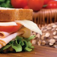 Turkey Deluxe Sandwich · Sliced turkey breast, Swiss cheese, mayo, lettuce, tomato and bacon tomato dressing. Served ...