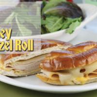 Turkey Pretzel Roll · Thinly sliced turkey breast, melted Swiss cheese and honey Dijon dressing served on Camille'...