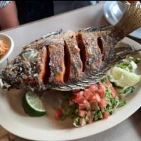 Mojarra · Golden deep fried whole fish topped with jalapeno butter.