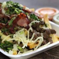 Asada Fries · A bed of fries, topped with asada, cheese, bacon, onion, and cilantro.