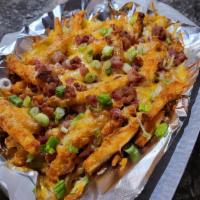 loaded fries · Battered fries topped with cheddar jack cheese, bacon, scallions and a side of sour cream.