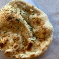 Garlic Naan · Bread stuffed with fresh minced garlic and herbs, baked in tandoor clay oven.