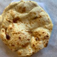 Plain Naan · Unleavened white bread baked in tandoor clay oven.