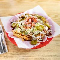 Slow-Smoked BBQ Pork Nachos · Topped with BBQ sauce, queso, sour cream, lettuce, pico and jalapenos.