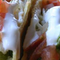 Mahi Mahi Tacos · Beer-batter fried or grilled. Topped with Latin slaw, garlic sauce and served with black bea...