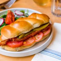 Schnitzel Sandwich · Breaded chicken breast, aioli, tomato and pickles on challah.