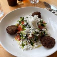 Israeli Salad · Chopped Israeli salad w/Tomato, Cucumbers, Red onions, Tahini, Lemon, Feta, Falafel