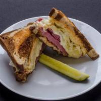 Reuben Sandwich · Thin sliced corned beef with sauerkraut and melted Swiss on toasted marbled rye and 1000 Isl...