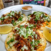 Birria Tacos (3/order) · Warm Corn Tortilla's, Slow cooked shredded beef, Onions, Cilantro, Lemon, Salsa on the side