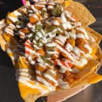 Buffalo Chicken Nachos · Grilled chicken, Buffalo sauce, tortilla chips, nacho cheese, ranch and giardiniera peppers.