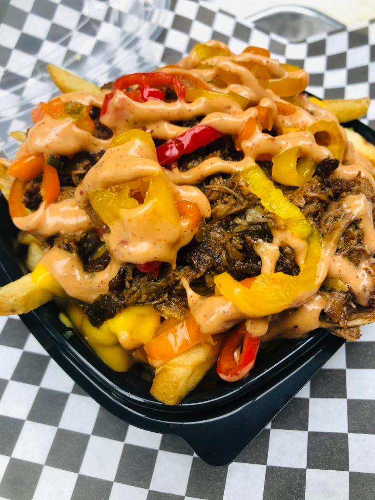 Loaded Pork Fries · Chive fries, braised pork, cheese sauce, pickled sweet and spicy peppers, bacon crumbled and BBQ aioli. ​
