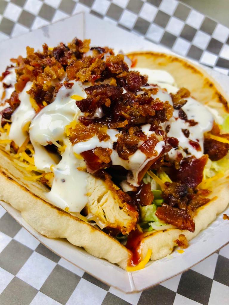 BBQ Chicken Bacon Ranch Pita · Fresh pita bread, BBQ chicken tenders, lettuce, cheddar Jack, ranch, BBQ and bacon crumbles. Served with chive fries.
