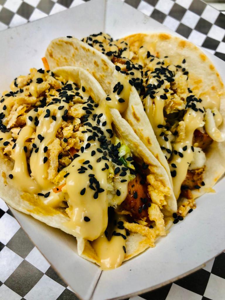 Korean Chicken Taco · Grilled chicken, Korean BBQ, southern slaw, French onion and sesame aioli.