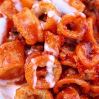 Buffalo Calamari  · Fried calamari tossed in Buffalo sauce topped with a ranch drizzle.