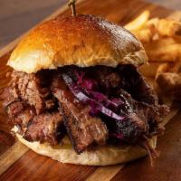 Brisket Sandwich · Our mouth-watering slow-cooked BBQ brisket, slaw, pickles, and Streats sauce.
