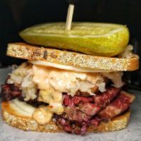 The Reuben · Housemade pastrami, sauerkraut, Swiss cheese, Russian dressing, toasted rye, and pickle.