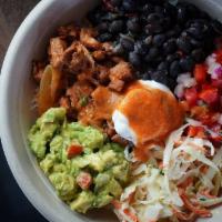 Mexi Bowl · Chicken, rice, slaw, beans, pico de gallo, guacamole, and crema.