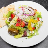 Greek Salad · Lettuce, tomatoes, feta cheese, Kalamata olives, peppers, onions and stuffed grape leaves. 