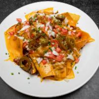 Nachos Grande · nachos with 
Chopped tomatoes, cheddar cheese, onions and jalapenos. Served with sour cream,...
