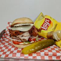 Turkey Club · Bacon and provolone cheese over freshly sliced turkey on a toasted Costanzo roll. Topped wit...