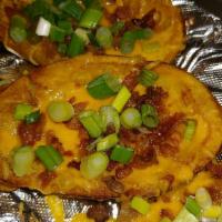 Potato Skins · Stuffed with cheddar and bacon, topped with scallions and served with a side of sour cream.