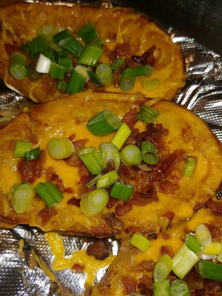 Potato Skins · Stuffed with cheddar and bacon, topped with scallions and served with a side of sour cream.