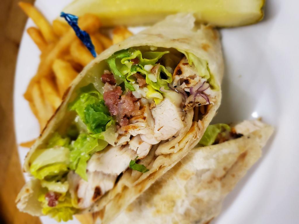 Chicken Caesar Wrap · Grilled chicken with lettuce, Parmesan, red onion, bacon bits and Caesar dressing. Served with chips and a pickle.