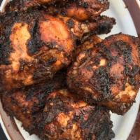 Jerk Chicken · Chicken rub and marinated with Jamaican spices and grilled slowly on charcoal grill.