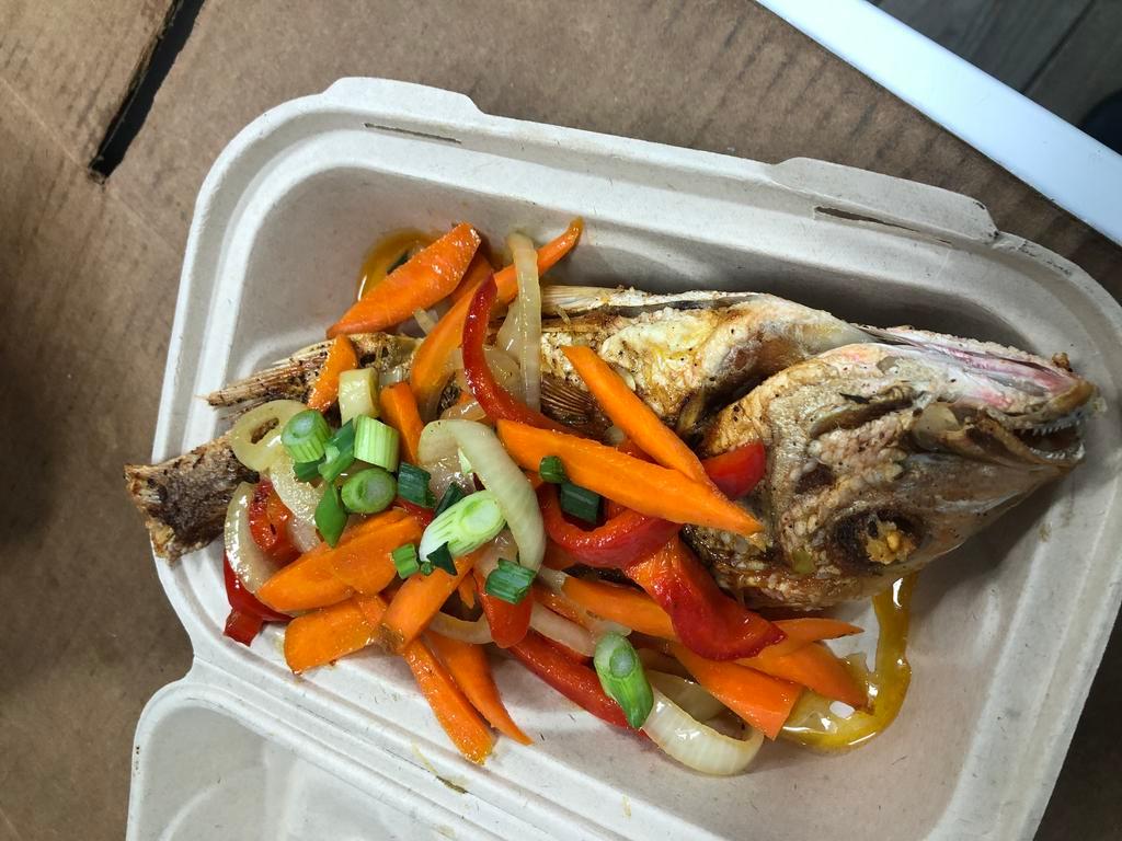 Escovitch Snapper · Red snapper seasoned to perfection, fried with toppings of onion, peppers, carrots in vinegar sauce. 