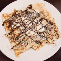 Nutella Banana Crepes · Topped with powdered sugar and whipped cream.