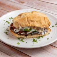Carne Asada / Grilled Steak Torta · Traditional Mexican sandwich, served on a telera toasted bread, coated with refried beans an...